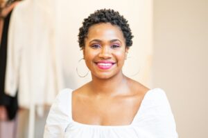 woman in white scoop neck shirt smiling